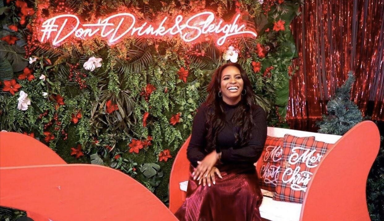 Immersive themed Christmas pop-up bar activation in Houston with neon signage and lush florals